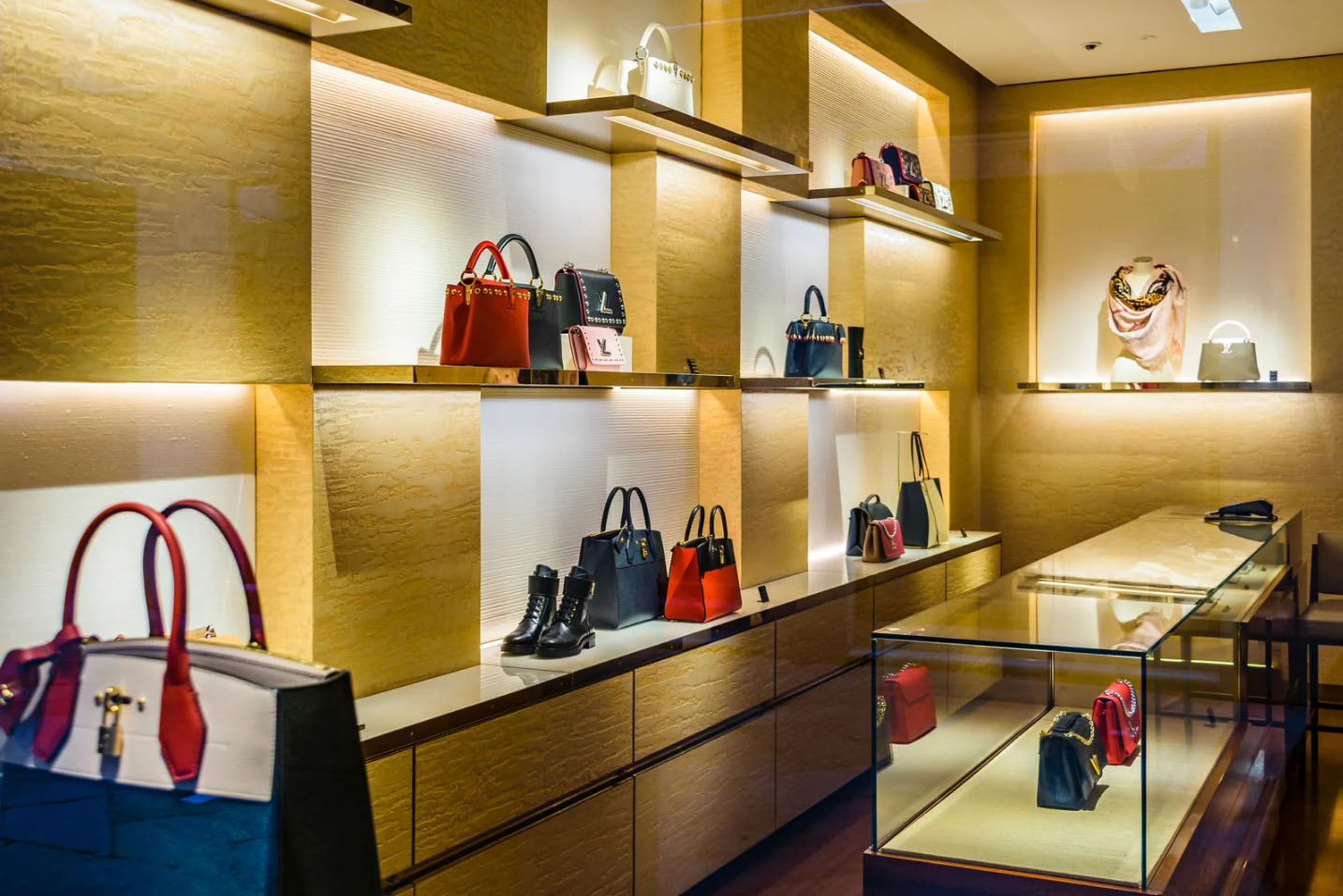 Luxury boutique in Milan displaying designer handbags, shoes, and accessories in an elegant, well-lit showroom.